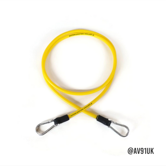 Yellow resistance band with foam handles and carabiner clips. Perfect for strength, boxing, and mobility training at home or in the gym. Portable and durable.